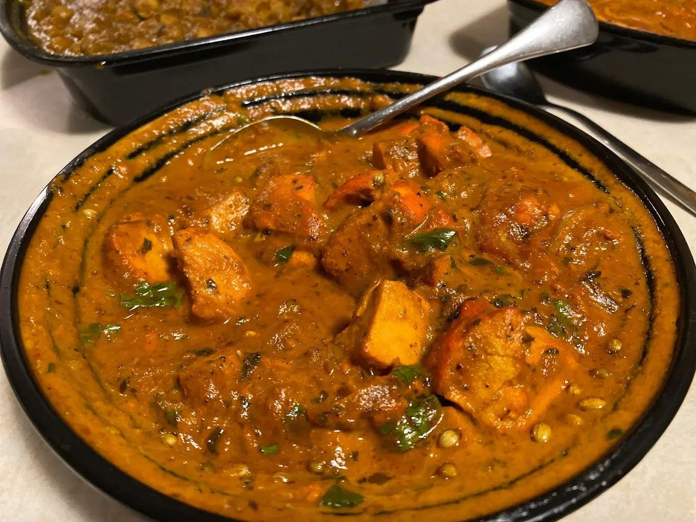 Freshly prepared Butter Chicken and Biryani ready for delivery at Aanchal in Edmonton